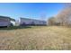 The exterior of the home exhibiting a spacious lawn and car port at 355 Branchwood Rd, Statesville, NC 28625
