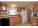 Functional kitchen featuring wood cabinetry and white appliances providing an efficient cooking space at 355 Branchwood Rd, Statesville, NC 28625