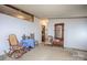 Cozy living area with a charming rocking chair, a decorative mirror, and ample natural light, perfect for relaxation at 355 Branchwood Rd, Statesville, NC 28625