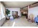 Bright living room featuring neutral carpet, a decorative cabinet, and natural light, creating a welcoming atmosphere at 355 Branchwood Rd, Statesville, NC 28625