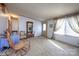 Bright living space showcasing a rocking chair, a coat rack, and a window with curtains, offering a comfortable entry at 355 Branchwood Rd, Statesville, NC 28625