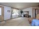Well-lit living room featuring a decorative cabinet, neutral carpet, and bright windows, creating a cozy and inviting space at 355 Branchwood Rd, Statesville, NC 28625