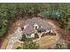 Stunning aerial view of home on a wooded lot with a tranquil pond at 4009 Beechwood Spring Ln, Belmont, NC 28012