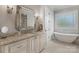 Spa-like bathroom featuring a soaking tub, granite vanity, and elegant fixtures at 4009 Beechwood Spring Ln, Belmont, NC 28012