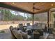 Inviting covered patio features comfortable seating and a ceiling fan for outdoor relaxation at 4009 Beechwood Spring Ln, Belmont, NC 28012