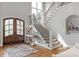 Elegant foyer with hardwood floors, staircase and decorative console table showcasing a warm welcome at 4009 Beechwood Spring Ln, Belmont, NC 28012