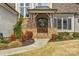 Grand front entrance with a stone portico and custom wood doors at 4009 Beechwood Spring Ln, Belmont, NC 28012