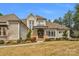 Inviting front of house with a beautiful stone facade and manicured lawn at 4009 Beechwood Spring Ln, Belmont, NC 28012