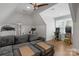 Attic game room with gray couch, treadmill, and arcade games at 4009 Beechwood Spring Ln, Belmont, NC 28012