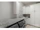 Spacious laundry room with granite countertops, white cabinets, and modern washer/dryer at 4009 Beechwood Spring Ln, Belmont, NC 28012