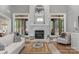 Bright living room features stone fireplace and a rustic wooden coffee table on a patterned rug at 4009 Beechwood Spring Ln, Belmont, NC 28012