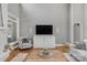 Bright living room showcasing hardwood floors, a modern television, and comfortable seating at 4009 Beechwood Spring Ln, Belmont, NC 28012