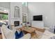 Spacious living room featuring a white stone fireplace, modern television, and hardwood floors at 4009 Beechwood Spring Ln, Belmont, NC 28012
