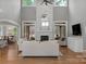 Bright, open living room features a stone fireplace, hardwood floors, and lots of natural light at 4009 Beechwood Spring Ln, Belmont, NC 28012