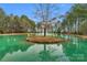 Picturesque view of the pond with a small island and tree reflecting in the water at 4009 Beechwood Spring Ln, Belmont, NC 28012