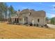 Expansive home exterior featuring a covered patio and generous yard space at 4009 Beechwood Spring Ln, Belmont, NC 28012