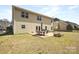 Spacious backyard featuring a patio with outdoor dining set and a small brick fire pit at 4035 W Sandy Trl, Fort Mill, SC 29707