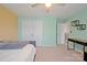 Bedroom with light green walls, complemented by a ceiling fan and a double door closet for storage at 4035 W Sandy Trl, Fort Mill, SC 29707