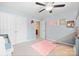 Bright bedroom with a ceiling fan, featuring a charming slide and pink rug, creating a delightful space at 4035 W Sandy Trl, Fort Mill, SC 29707