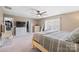 Spacious bedroom with walk-in closets, a ceiling fan, and large bed at 4035 W Sandy Trl, Fort Mill, SC 29707