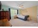 Bedroom features a blue day bed, window, and view of the backyard at 4035 W Sandy Trl, Fort Mill, SC 29707