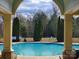 Stunning view of the community pool framed by stone columns and lush green trees at 4035 W Sandy Trl, Fort Mill, SC 29707