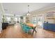 Open-concept dining area with wood floors that flows into a comfortable living space at 4035 W Sandy Trl, Fort Mill, SC 29707