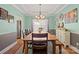 Light-filled dining room featuring a large wooden table, stylish lighting, and a serene ambiance at 4035 W Sandy Trl, Fort Mill, SC 29707