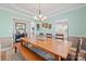 Light-filled dining room featuring a large wooden table, stylish lighting, and seamless kitchen access at 4035 W Sandy Trl, Fort Mill, SC 29707