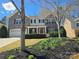 Beautiful two-story home with stone accents, a red front door, and manicured landscaping at 4035 W Sandy Trl, Fort Mill, SC 29707