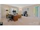 Open home office area features a desk, tv, and a comfortable couch at 4035 W Sandy Trl, Fort Mill, SC 29707