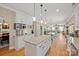 Open kitchen with granite countertops, a center island, and seamless flow into the dining and living areas at 4035 W Sandy Trl, Fort Mill, SC 29707