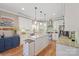 Modern white kitchen featuring granite countertops, stainless steel appliances, and center island at 4035 W Sandy Trl, Fort Mill, SC 29707