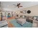 Spacious living area with wood floors, a large sectional, and an open view into the kitchen and dining area at 4035 W Sandy Trl, Fort Mill, SC 29707