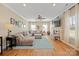 Spacious living room with a large sectional sofa, ceiling fan, and a TV mounted above the mantel at 4035 W Sandy Trl, Fort Mill, SC 29707