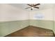 Bedroom with dark wood floors and green paneled walls at 4136 Woodgreen Ter, Charlotte, NC 28205
