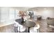 Dining room flows into the kitchen with stainless steel appliances and breakfast bar at 4136 Woodgreen Ter, Charlotte, NC 28205