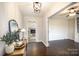 Inviting entryway with dark wood floors and decorative mirror at 4136 Woodgreen Ter, Charlotte, NC 28205