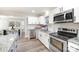 Well-lit kitchen featuring white cabinets, stainless appliances, and granite countertops at 4136 Woodgreen Ter, Charlotte, NC 28205