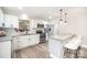 Modern kitchen with white cabinets, stainless steel appliances, and a granite countertop breakfast bar at 4136 Woodgreen Ter, Charlotte, NC 28205