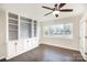 Bright living room features hardwood floors, built-in shelving, and French doors at 4136 Woodgreen Ter, Charlotte, NC 28205