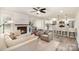 Open-concept living space featuring a fireplace, dining area, and modern kitchen at 4136 Woodgreen Ter, Charlotte, NC 28205