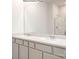 Bathroom featuring a double vanity with gray cabinets and a glass-enclosed shower at 5231 Reedy Ridge Rd, Charlotte, NC 28215