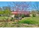 Charming brick home featuring a cozy backyard patio and lush landscaping for outdoor enjoyment at 602 Dallas Spencer Mountain Rd, Dallas, NC 28034