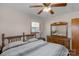 Comfortable bedroom with ceiling fan, window, and wooden furniture at 602 Dallas Spencer Mountain Rd, Dallas, NC 28034