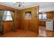 Dining area with wood paneling and adjacent kitchen at 602 Dallas Spencer Mountain Rd, Dallas, NC 28034