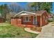 Charming brick home featuring a quaint, covered front porch with a wrought iron railing at 602 Dallas Spencer Mountain Rd, Dallas, NC 28034