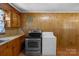 Laundry room features wood paneling, countertop, washing machine and dryer at 602 Dallas Spencer Mountain Rd, Dallas, NC 28034