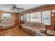 Inviting living room featuring a large window, wood-paneled walls, and hardwood floors at 602 Dallas Spencer Mountain Rd, Dallas, NC 28034