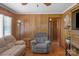 Comfortable living room with a wood-paneled accent wall and neutral-toned furnishings at 602 Dallas Spencer Mountain Rd, Dallas, NC 28034